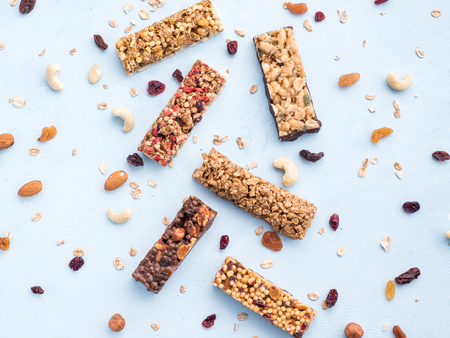 Set of different granola bars on blue backgroundの写真素材