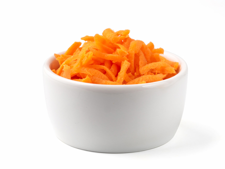 Grated carrots isolated on whiteの写真素材