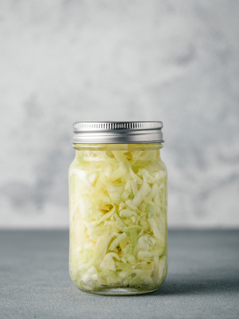 Sauerkraut in open glass jar, copy spaceの写真素材