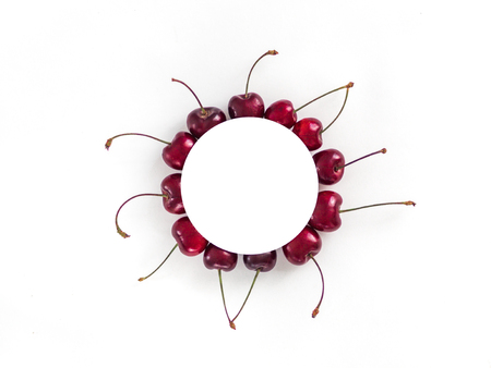 Creative layout with fresh ripe berries. cherry isolated on white background with white circle for copy space. Can use for your design, promo, social media, Top viewの写真素材