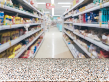 Marble board empty table in front of blurred background. Perspective table over blur in supermarket - can be used for display or montage your products. Mockup for display of product.の写真素材