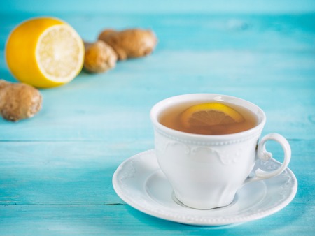 ginger tea with lemon on blue background with copy spaceの写真素材