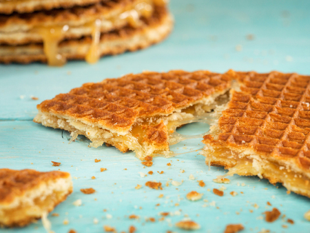 Stroopwafels or caramel Dutch Waffle close up on turquoise wooden backgroundの写真素材