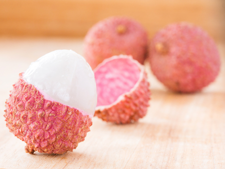 lichee fruit on wooden background close upの写真素材
