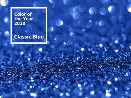 Sparkling background with bokeh made of Classic Blue 2020 color. Color of year 2020 blurred backdrop for holidays and parties. COY2020 Classic Blue concept. Copy space for textの写真素材
