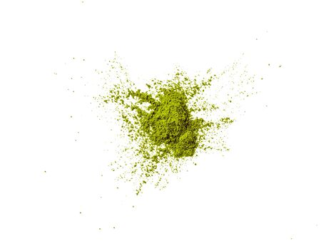 Green matcha tea powder on white background. Powdered maccha tea explosion, isolated on white with clipping path. Top view or flat lay. Copy space for text or designの写真素材