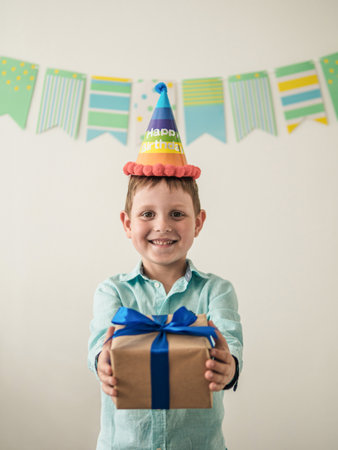 Five year old boy in his birthday hold gift boxの写真素材