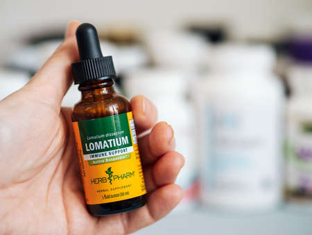 Bottle with Lomatium in female handのeditorial素材