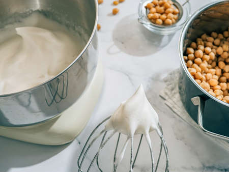 Whipped aquafaba in planetary mixer. Chickpea water brine aquafaba whipped. Egg replacement in coocking. Vegan concept. Top view or flat lay. Hard lightの写真素材