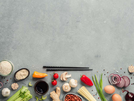 Asian food ingredients with copy space. Various of Chinese cooking ingredients and chopsticks on gray stone background. Asian food concept. Copy space for text. Top view or flat lay. Hard lightの写真素材