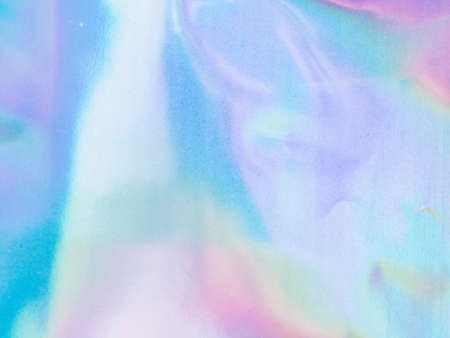 Beautiful holographic rainbow abstract background in pastel and neon color design. Real photography shot of holographic foil for creative project - design fashion, cover, book, printing. Copy spaceの写真素材