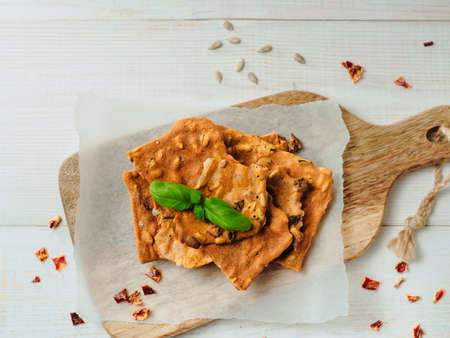 Gluten-freen crispbreads made of buskwheat flour. Green buckwheat flour smoked paprika sunflower seeds ingredients homemade baked crisp bread. Idea recipe snacks gluten free concept. Top view flat layの写真素材