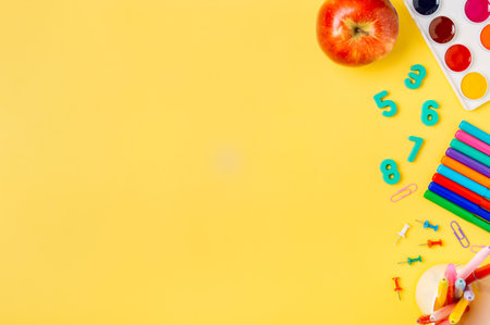 Education, back to school, freelancer work concept. School supplies, stationery accessories over yellow background. Flat lay, top view. Copy spaceの写真素材