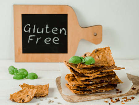 Gluten-freen crispbreads made from buskwheat flour. Green buckwheat flour, smoked paprika, sunflower seeds is ingredients for this homemade baked crisp bread. Idea recipe snacks, gluten-free conceptの写真素材