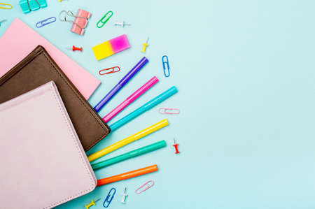 School supplies, stationery accessories on blue background. Copy space. Top view flat lay. Education, back to school, freelancer work concept. Long horizontal bannerの写真素材