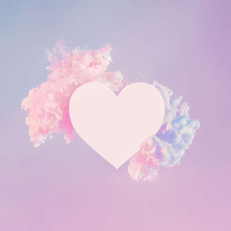 Creative abstract neon hearth-shape background with copy space. Empty white heart shape in clouds made from white paint in pink neon light. Neon minimal creative composition for Valentines day designの写真素材