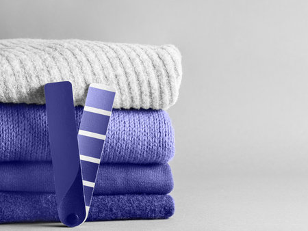 Stack of sweaters and color fun palette in violet color of 2020 year very peri. Demonstrating color of 2022 year very peri for fashion and clothing industry. Copy spaceの写真素材