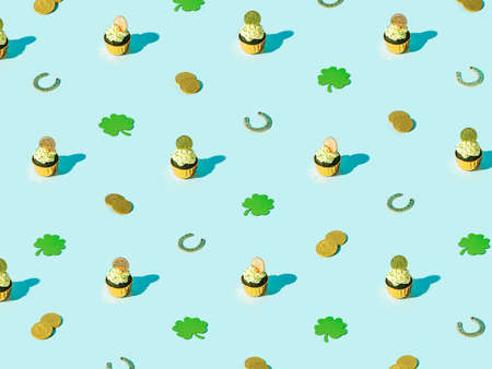 St Patricks Day isometric patternt. Lucky symbols and sweet food for Saint Patricks Day party concept. Green velvet cupckake, shamrock, golden coin and horseshoe on blue backgroundの写真素材