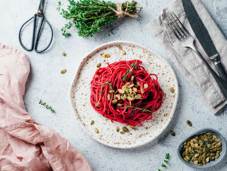 Beetroot pesto or hummus. Homemade beet pesto sauce in glass jar and fresh thyme on dark black background. Copy space for text. Ideas and recipes for healthy vegetarian detox diet foodの写真素材