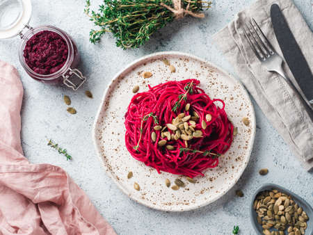 Beetroot pesto or hummus. Homemade beet pesto sauce in glass jar and fresh thyme on dark black background. Copy space for text. Ideas and recipes for healthy vegetarian detox diet foodの写真素材