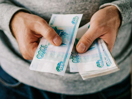 Hands counting russian rubles. Selective focus. Shallow DOFの写真素材