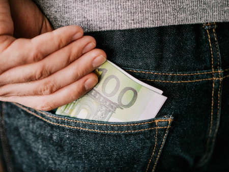 his hand put Euro in jeans pocket or take out from pocketの写真素材