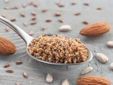 Homemade LSA mix in spoon - Linseed or flax seeds, Sunflower seeds and Almonds. Traditional Australian blend of ground, source of dietary fiber, protein, omega fatty acids. Copy space for text.の写真素材