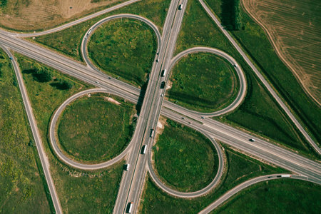 Clover or daisy type of road junction. Aerial top down view of beautiful highway road junction in...