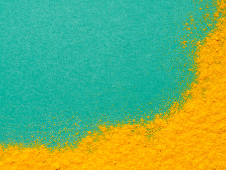 Turmeric Powder or Curcuma longa on green background. Top view. Copy space for text.の写真素材