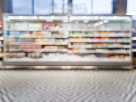 Defocused blur of supermarket shelves with dairy products. Blur background with bokeh. Defocused imageの写真素材