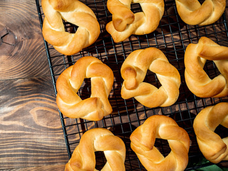 Taralli twist on wooden background. Typical italian ring-shaped or doughnut-shaped biscuit cookies or appetizers for wine Taralli or Taralle. Top view or flat lay. Copy spaceの写真素材