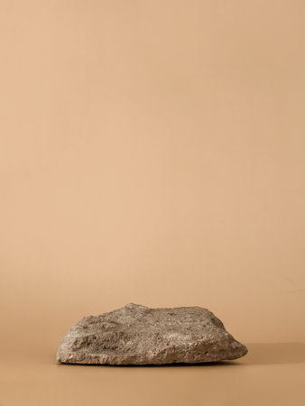 Mockup geometric shape natural rock podium. Stone shape on pastel light beige background. Can use as perfume and cosmetic mock up. Copy space. Verticalの写真素材