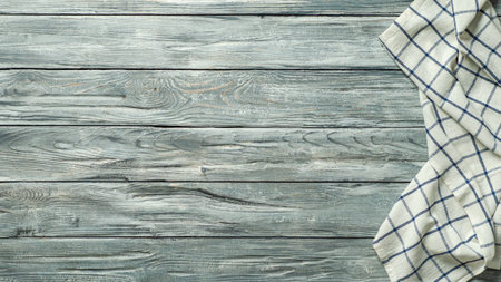 Gray wooden table with linen kitchen towel or textile napkin flat lay. Blue tablecloth on old gray wood tabletop. Copy space for text. Can use as mock up for design. Long horizontal bannerの写真素材