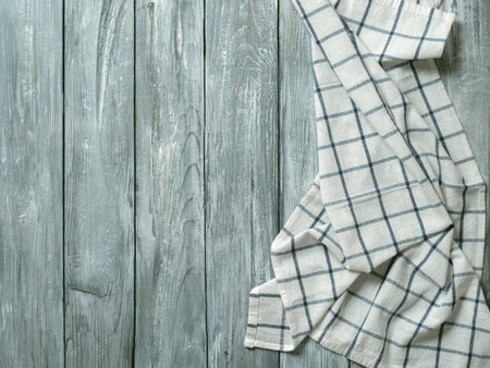 Gray wooden table with linen kitchen towel or textile napkin flat lay. Blue tablecloth on old gray wood tabletop. Copy space for text. Can use as mock up for design.の写真素材