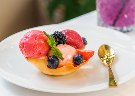 Berry sorbet with three flavors - strawberry, raspberry, black currant. Scoop ice cream sorbet decorated fresh berries and mint. Summer ice cream conceptの写真素材