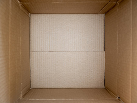 Opened cardboard box close up. Empty open rectangular cardboard box close up background and textureの写真素材