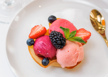 Berry sorbet with three flavors - strawberry, raspberry, black currant. Scoop ice cream sorbet decorated fresh berries and mint. Summer ice cream conceptの写真素材