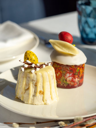Traditional Easter cottage cheese dessert Paskha decorated with quail eggs and chocolate willow on tabletop background. Modern Orthodox Easter background with two mini cottage curd desserts Paskhaの写真素材