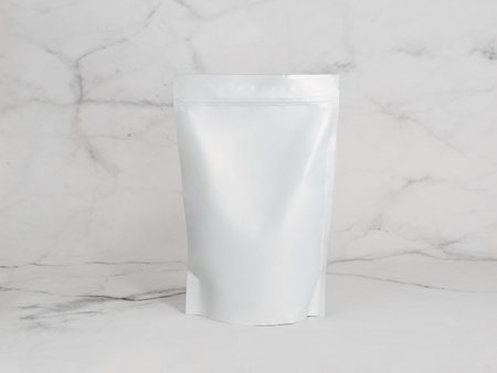 White zipper bag on marble background. Blank packaging white zipper pouch on white marble background ready for food product packaging design mock-upの写真素材