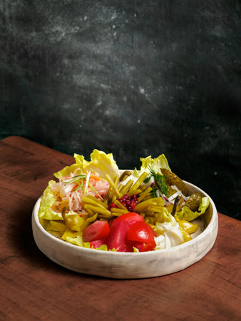 Assorted snacks from fermented cabbage, cucumbers and tomatoes, green bean. Decorated cranberry. Fermented healthy food concept. Pickled cucumbers, marinated tomatoes Vertical.の写真素材