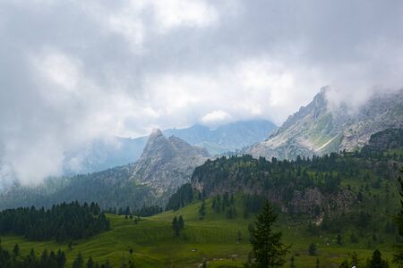 beautiful clouds on the peaks of the Dolomites   near Cortina on a strange summer dayの写真素材