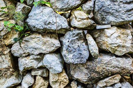 ancient wall of stones and mortar with bricks and wood, Valle dei Mulini in Lusiana in the Province of Vicenzaの写真素材