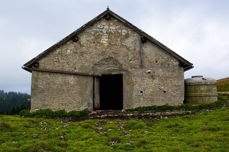 frontal image of a stable in the mountains near the Melette on the Asiago plateau near Vicenza, Italy.の写真素材