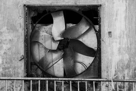 old industrial fan stopped and abandoned sign of an impending declineの写真素材