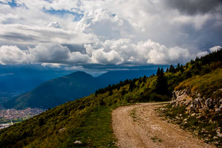 wonderful white clouds form magnificent shapes with the green of the mountains in Caltrano, Vicenza, Veneto, Italyの写真素材