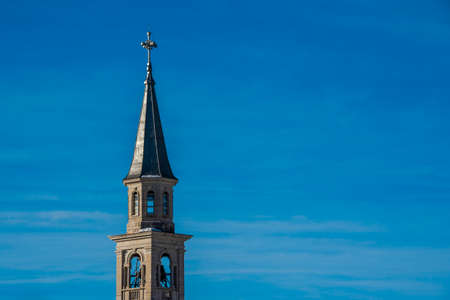 bell tower with tin roof and cloudy sky in the background in Camporovere, Asiago, Vicenza, Italyの写真素材