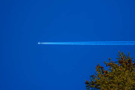 contrails planes on blue sky with white clouds in the val di Zoldo, Belluno, Italy