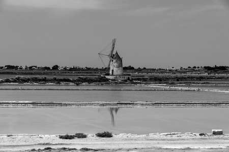 the Saline di Marsala in the Stagnone lagoon with old windmills and salt marshes in Marsala Trapani Sicily Italyの写真素材