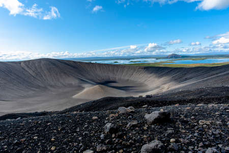 crater of Hverfjall volcano with black lava rocks in the background Lake Myvatn in the Austurland region of Icelandの写真素材