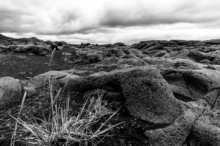 expanses of lava rock with black and deep red colors in the crater of vulcan Askja in the Vatnajokull national park in icelandの写真素材